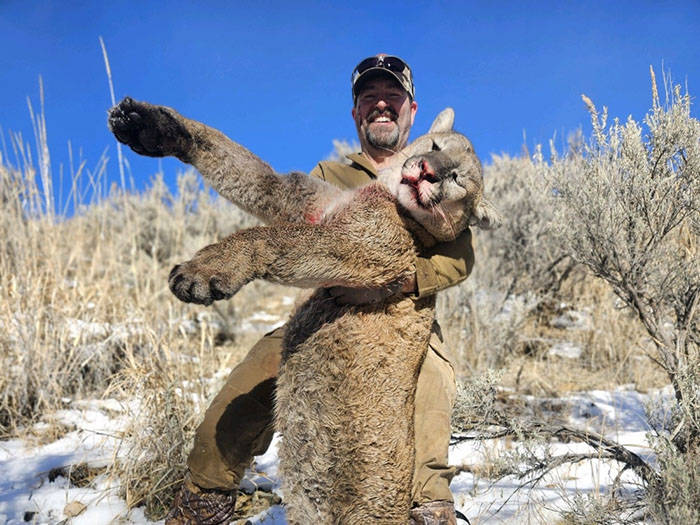 Lion Hunter holding prize.